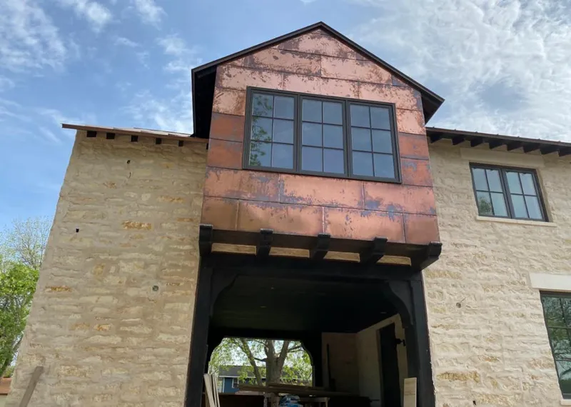 Copper metal panel facade on a stone building for Roof Repair in Bardstown